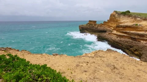 Turquoise Ocean Cove and Limestone Cliffs with Crashing Waves, South Lombok Stock Footage 341820079