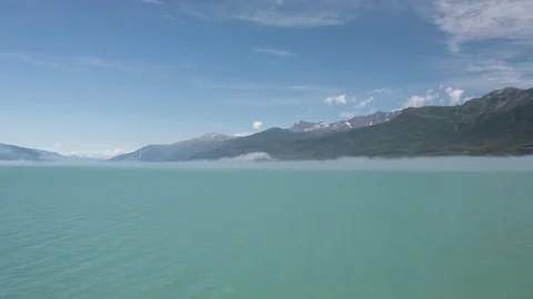 Turquoise ocean with mountains Stock Footage 70343435