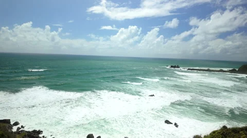 Turquoise ocean panorama with rolling surf and distant rocks Stock Footage 325850258