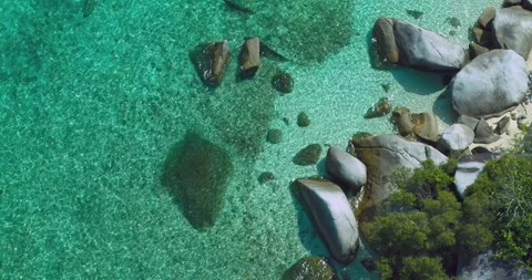 Turquoise Ocean Texture Around Granite Shoreline Belitung Aerial Stock Footage 329773230