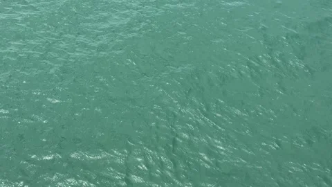 Turquoise Ocean Water Surface Rippling in Slow Motion Stock Footage 345774710