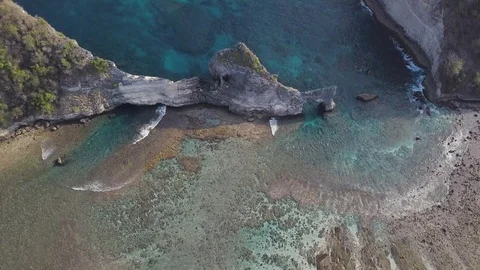 Turquoise ocean water surrounded by rocks aerial ocean footage Stock Footage 101989369