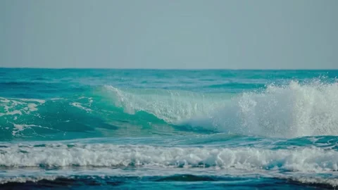 Turquoise ocean water wave crash on coast surface Stockbeeldmateriaal 344354909