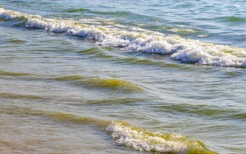 Turquoise ocean wave breaking on sandy tropical beach paradise summer. 写真素材