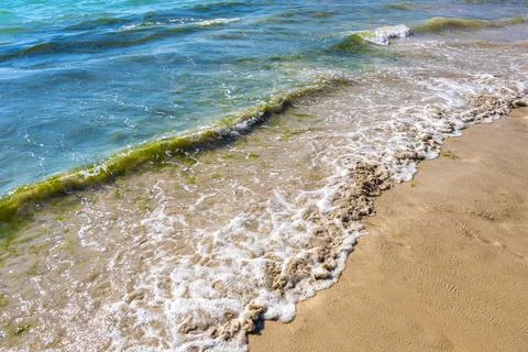 Turquoise ocean wave breaking on sandy beach tropical paradise background. 写真素材