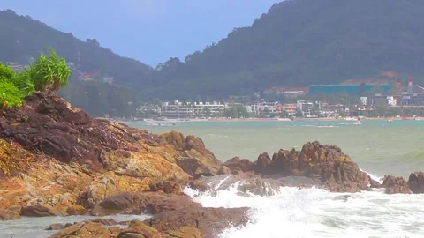 Turquoise ocean wave crashing on rocks Kalim Beach Phuket Thailand. Stock Footage 335692660