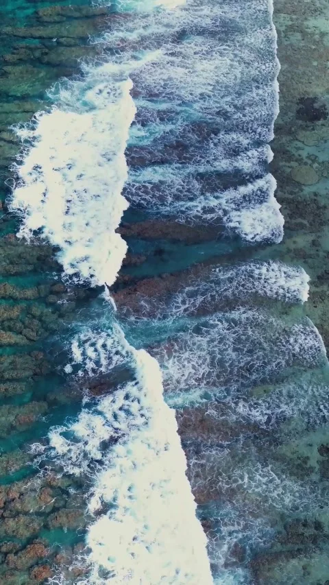Turquoise ocean waves breaking over a beautiful coral reef in the Maldives from Stock Footage 345760032