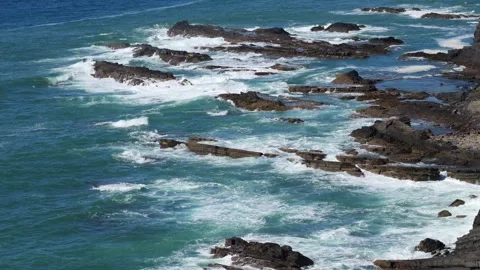 Turquoise Ocean Waves Crash Against Rugged Coastal Rocks in Portugal Stock Footage 318805705