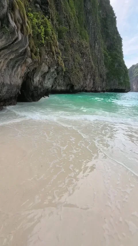 Turquoise Ocean Waves Crashing on Sand Beach Near Limestone Cliff Stock Footage 341900387
