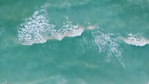 Turquoise ocean waves with white foam Stock Footage 325397639