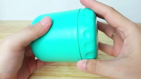 Turquoise Plastic Container on Wooden Surface Stock Footage 287849180