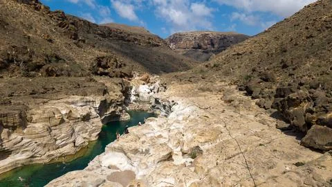 Turquoise pool in eroded limestone canyon Stock Photos