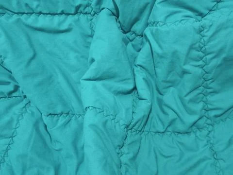 Turquoise Quilted Bedding Fabric Texture with Stitching and Folds Stock Photos