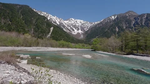 Turquoise River and Snow-Capped Mountains in Kamikochi, Japan – 4K Stock Footage 329773537