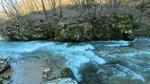 Turquoise River Flowing Downstream With White Rock Foreground Stock Footage 330951936