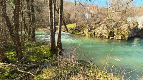 Turquoise River Flowing Left to Right in Sunny Autumn Vídeos de archivo 330941687