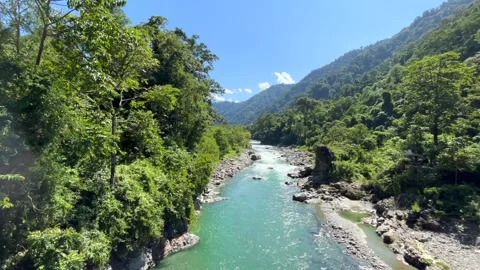 Turquoise River Flowing Through Lush Green Mountain Valley Stock Footage 329175144