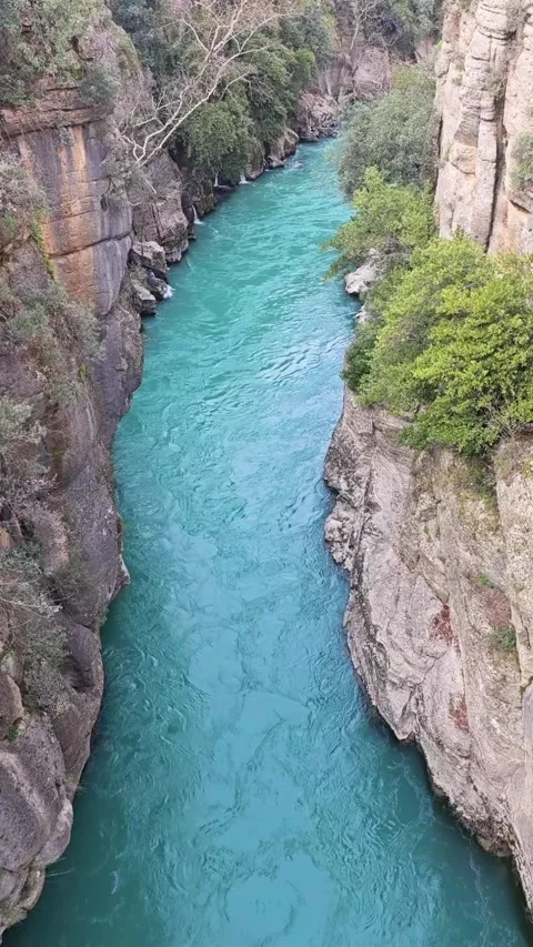 Turquoise River Flowing Through a Narrow Rocky Canyon Stock Footage 342230629
