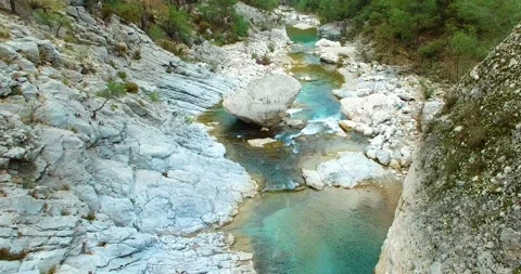 Turquoise River Flows on the Rocks 4k Drone Shot Stock Footage 148352075