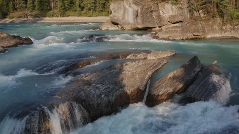 Turquoise River Rapids with Rock Formations in Lush Forest Stock Footage 255626917