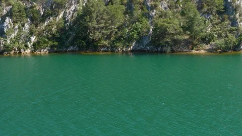 Turquoise river with rock cliff border background Stock Footage 90335332