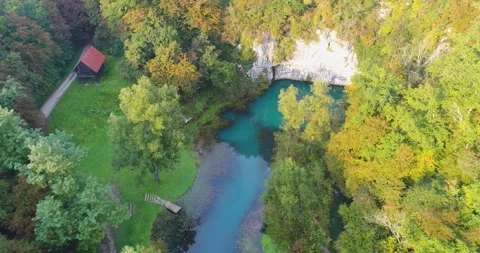 Turquoise river spring winding through forest, Slovenia, Video stock 326197275