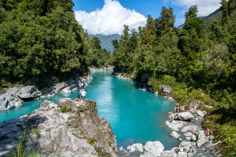 Turquoise River Surrounded by Lush Forests Stock Photos