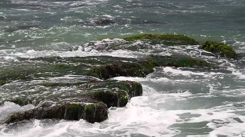 Turquoise rolling wave slamming on the rocks . Stock Footage 49490717