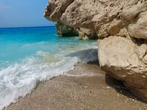 Turquoise rolling waves slamming on the rocks of the coastline Stock Footage 80050255