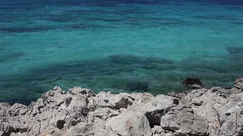 Turquoise sea and grey rocks Stock Footage
