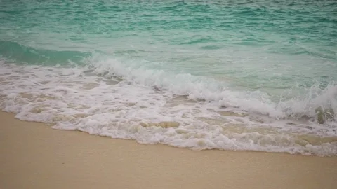 Turquoise sea wave on the sand beach, slow motion Stock Footage 232172499
