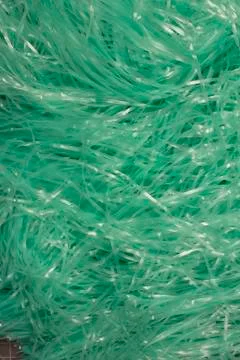 Turquoise shredded plastic fake Easter grass  Stock Photos