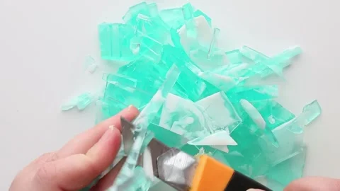 Turquoise soap being finely diced into irregular fragments, offering an ASMR Vídeos de archivo 313356040