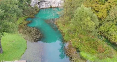 Turquoise spring river between grassy banks, Slovenia, Stock Footage 326198687
