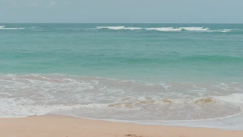 Turquoise surf rolling onto the beach , Nusa Dua, Bali 動画素材 336515240