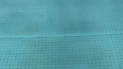 Turquoise surface of sunlit swimming pool.  Light ripples reflection refraction Stock Footage 266533875