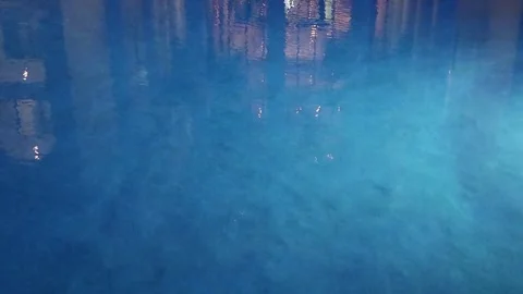 Turquoise surface of sunlit swimming pool.  Light ripples reflection refraction Stock Footage 266534318