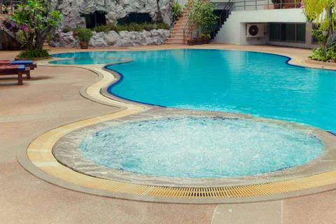 Turquoise swimming pool with jacuzzi Stock Photos