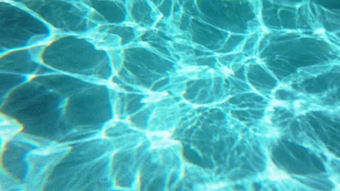 Turquoise Swimming Pool Water with Sunlight Caustic Patterns on Bottom. Stock Footage 339802431