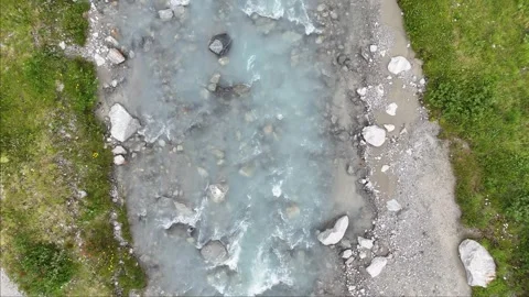 Turquoise transparent glacial water flow in glacier creek Stock Footage 313832034