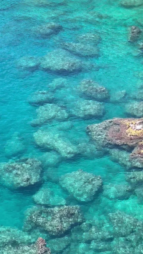 Turquoise transparent water surface with rocks inside Stock Footage 336947184