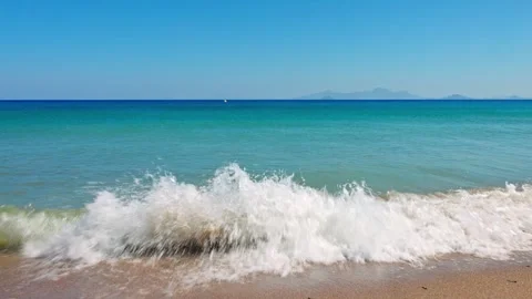 Turquoise transparent wave rolls onto Kos Island beach in the Aegean Sea Stock Footage 312957509