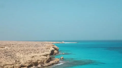 A turquoise tropical wave washes over the white sand beach and blue sea Stock Footage 329141372