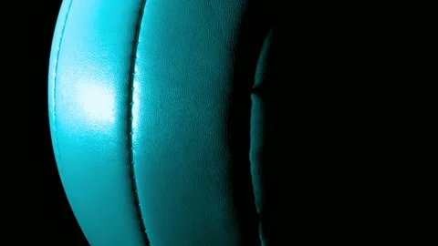 Turquoise volleyball slowly rotating with dramatic lighting close-up on bla.. Stock-Footage 341802105