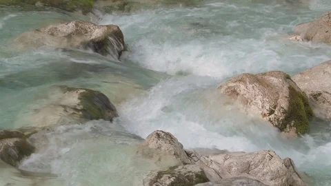 Turquoise water flows between white moss-grown stones in a beautiful forest 스톡 동영상 78045303