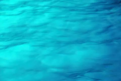 Turquoise water surface texture sunlight with a sun light Stock Photos
