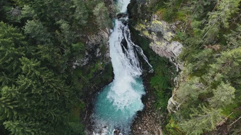 Turquoise waterfall cascading through lush green forest Video stock 283300524