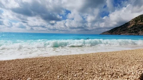 Turquoise Waters and Dramatic Limestone Cliffs of Myrtos Beach in Greece Stock Footage 311112812
