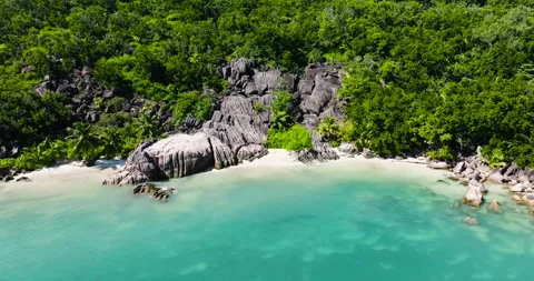 Turquoise waters and lush greenery with rocky shores. Praslin, Seychelles. Stock Footage 302854261