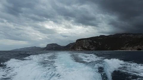 Turquoise wave and dramatic clouds on the coast, Mediterranean Sea, Sardinia 写真素材